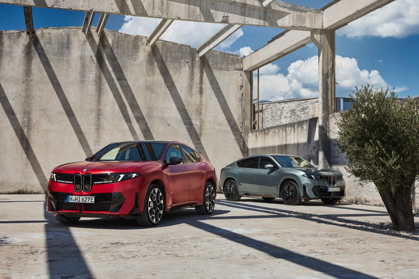 Zwei BMW iX4 vor moderner Architektur